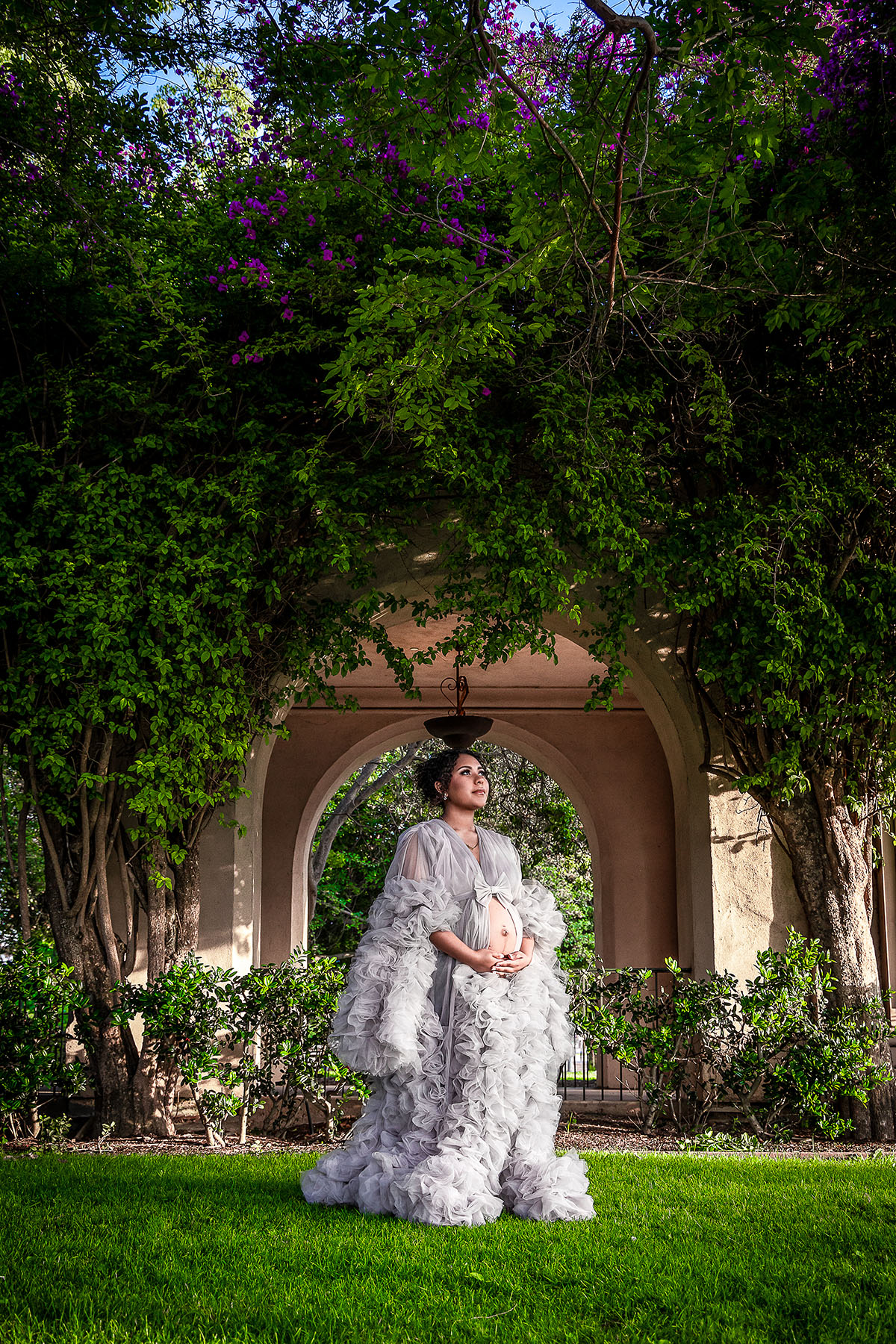 Pregnant mom in Balboa Park with trees in SanDiego