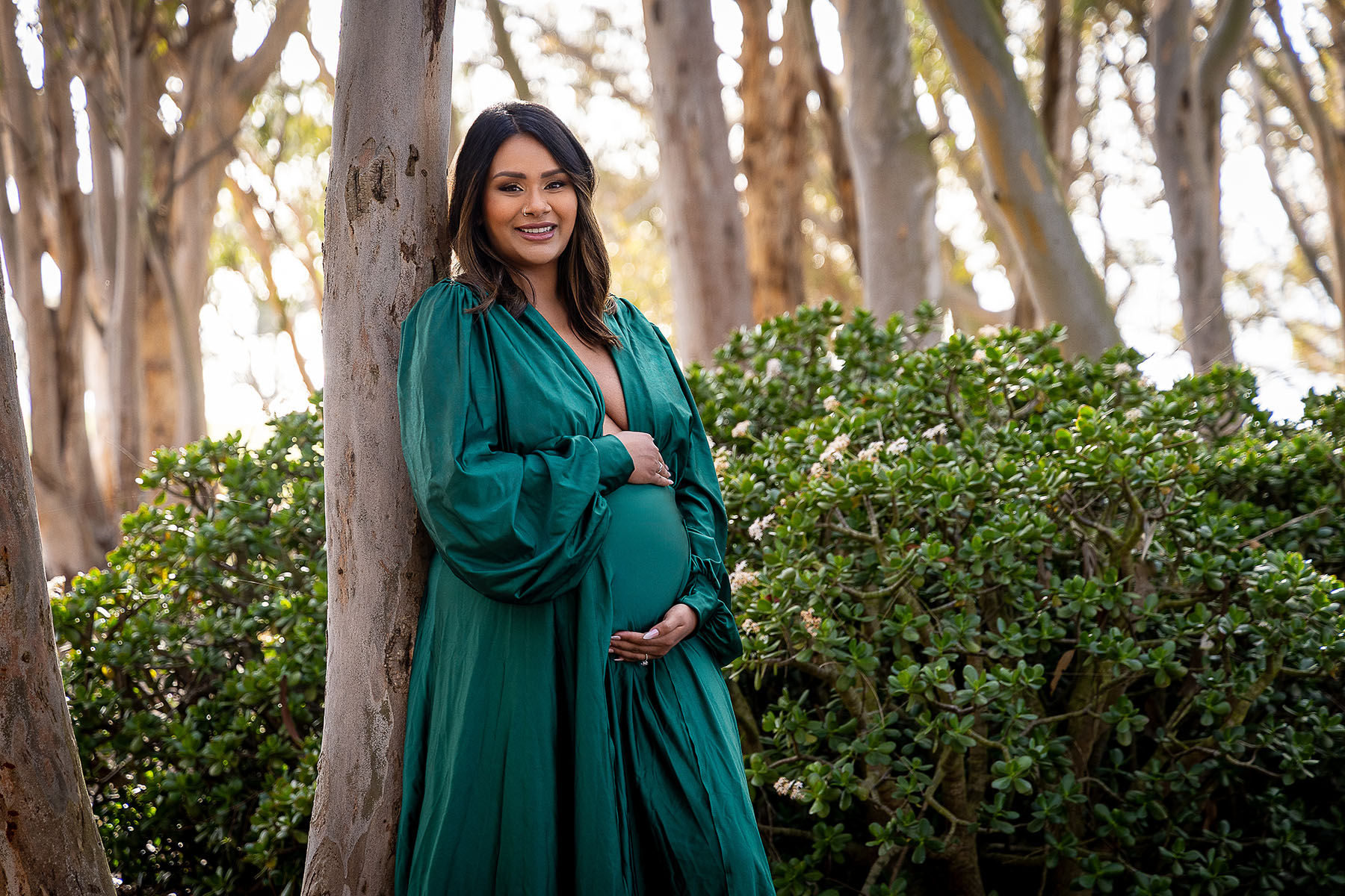 happy smiling pregnant mom in forrest