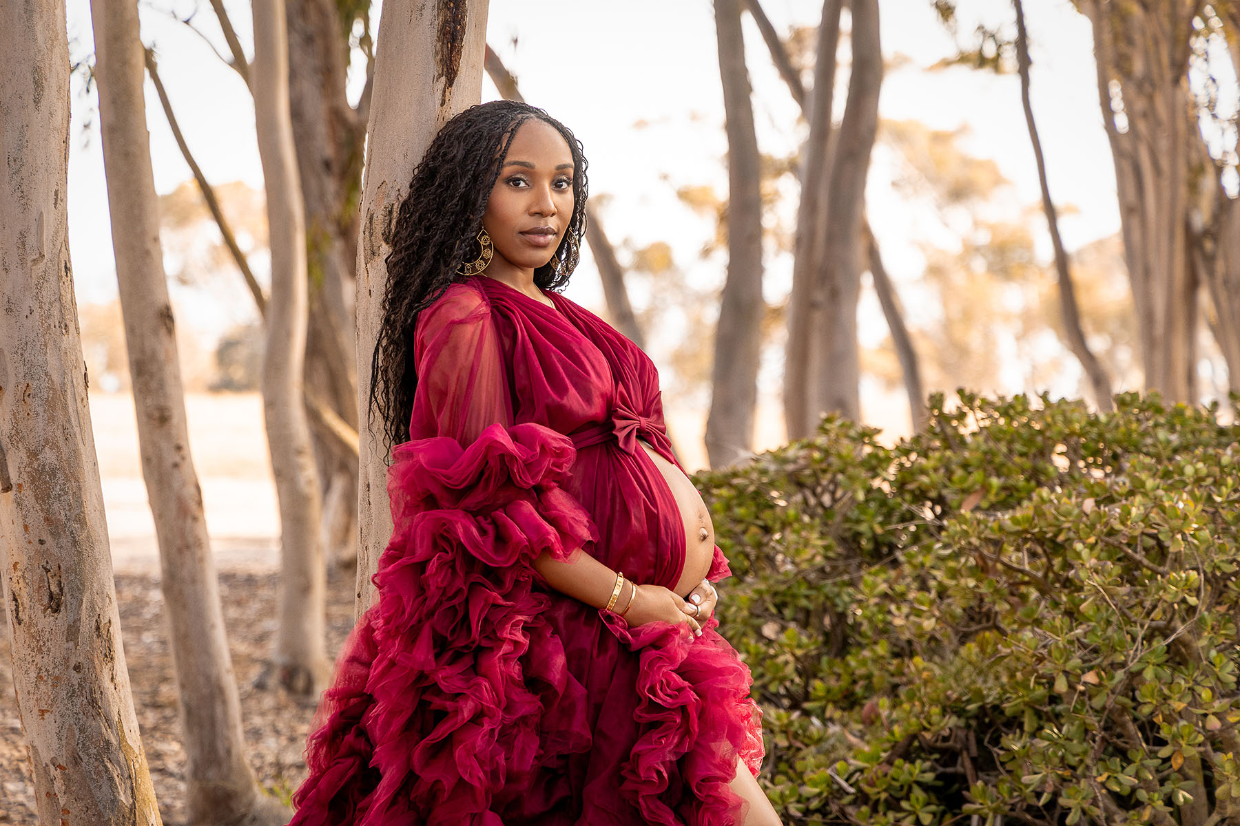 Pregnant mom in maternity dress in forrest of La Jolla