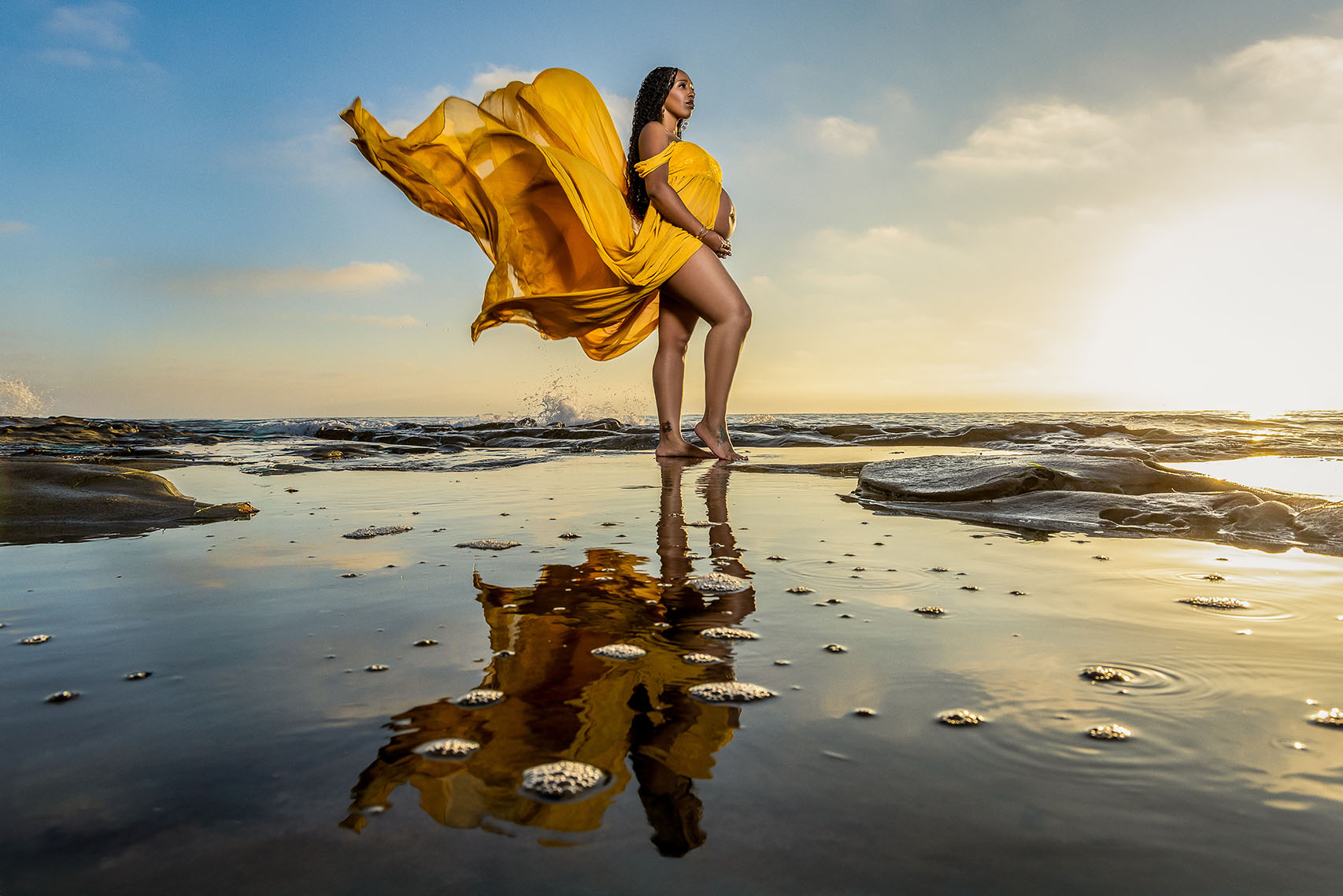 Flowing maternity dress on expecting mom in La Jolla coast