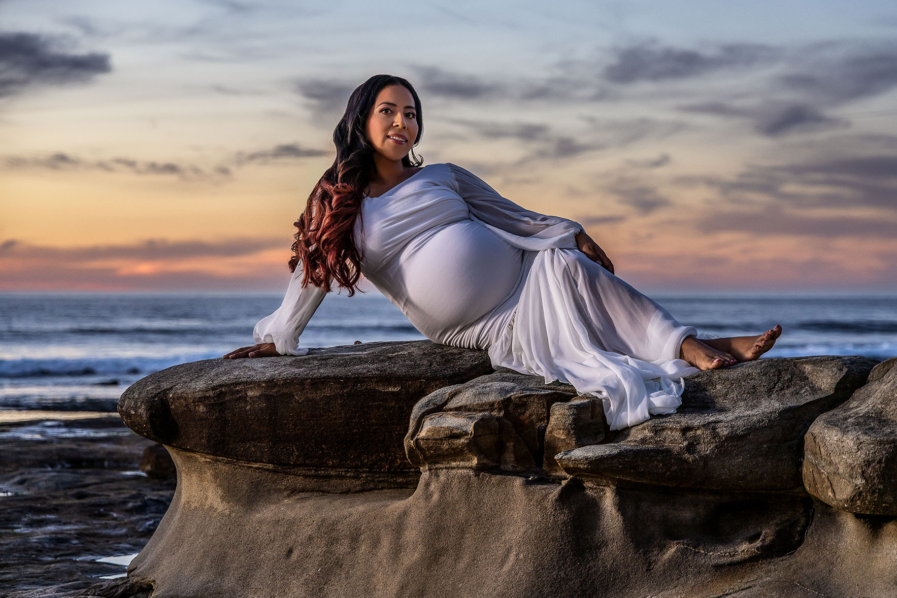 new mom laying on reef by the ocean in La Jolla