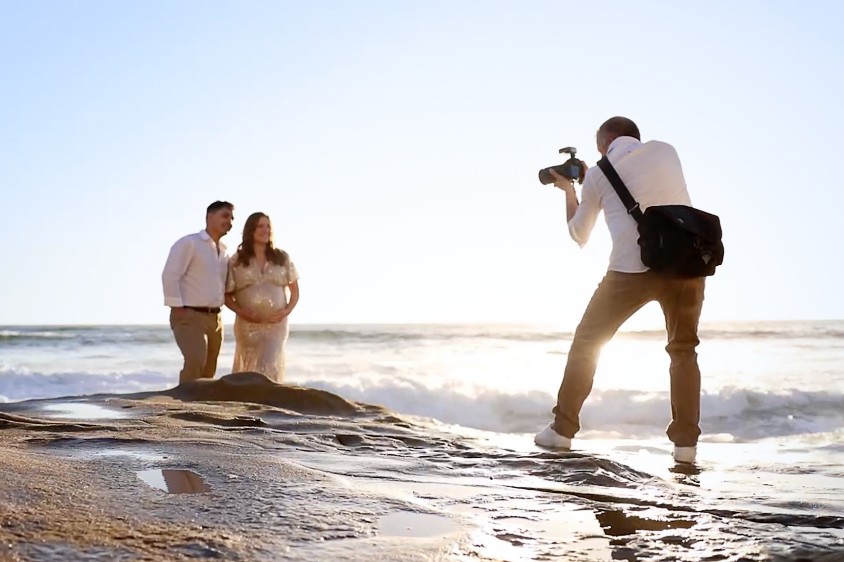 pro photographer taking maternity photos of couple in La Jolla