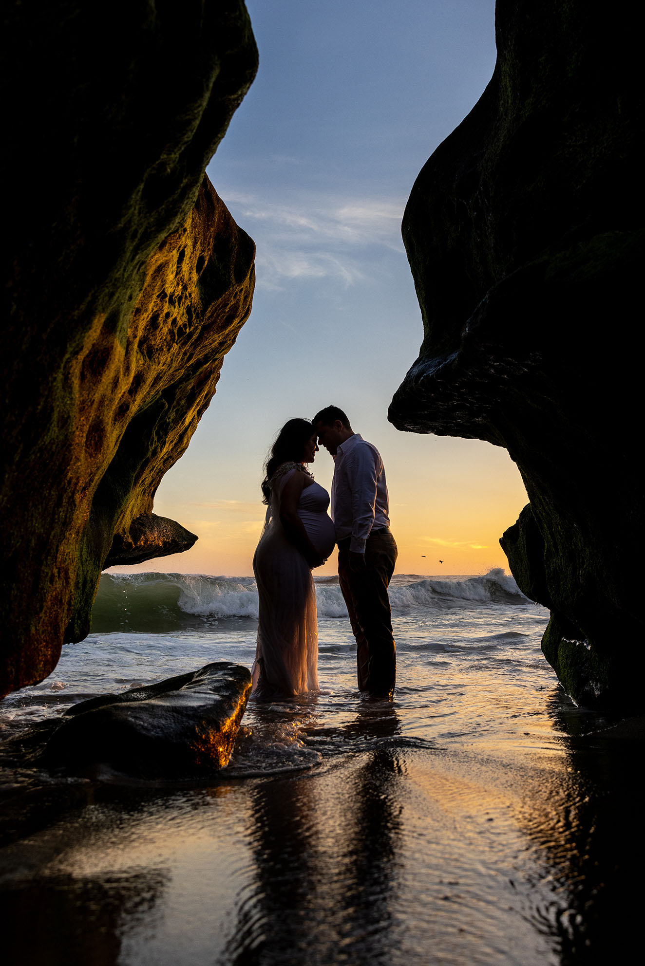 silhouette beach photo in cave of maternity couple in La Jolla
