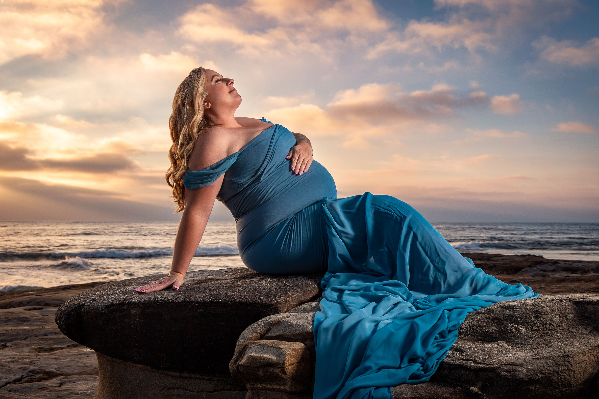 maternity woman on the cliffs in La Jolla with warm sunset