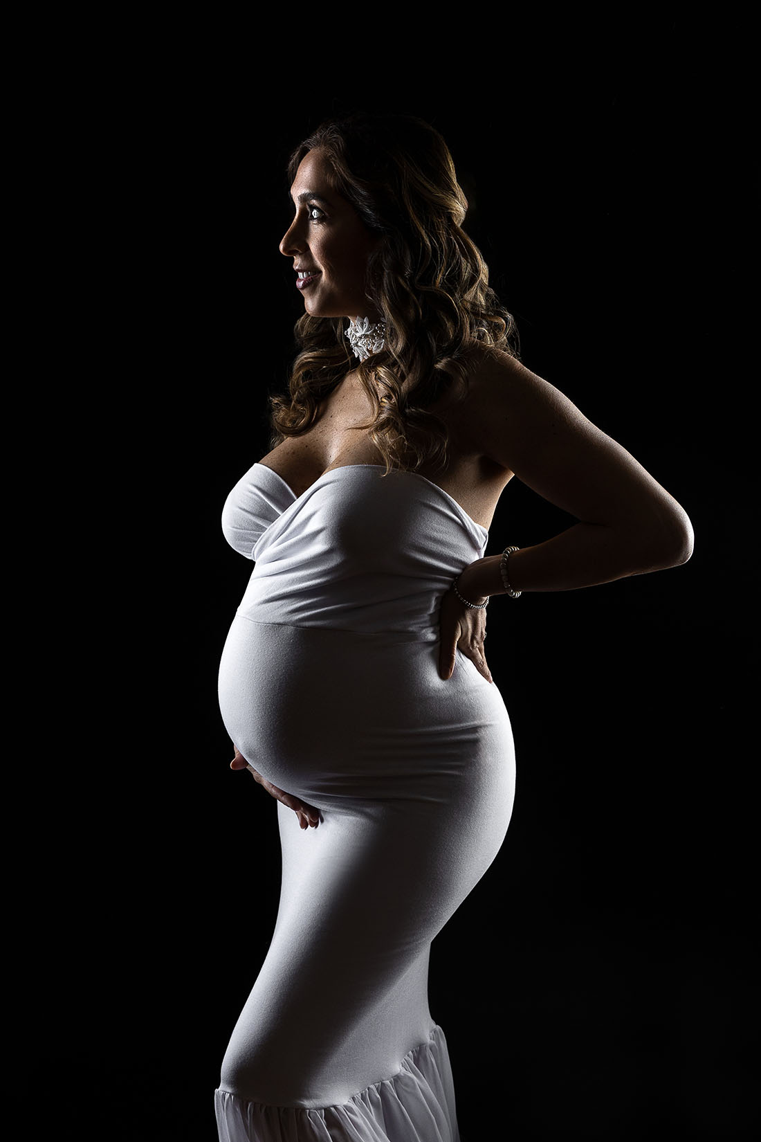dark moody edge lighting maternity photo in studio