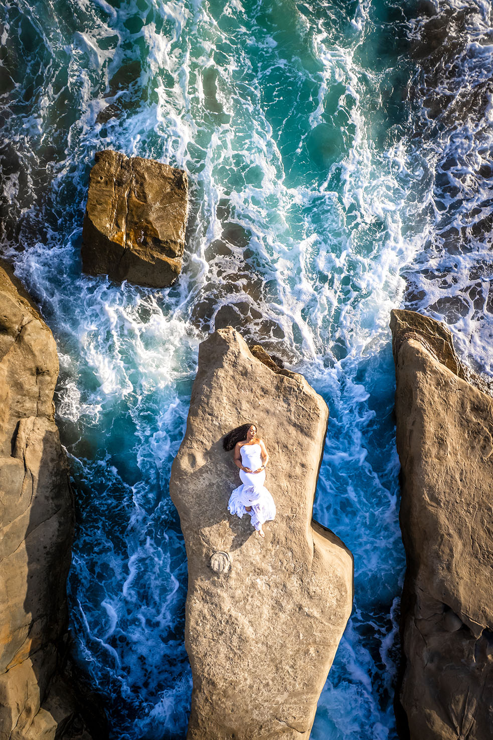 Aerial drone photo on La Jolla coast of maternity mom