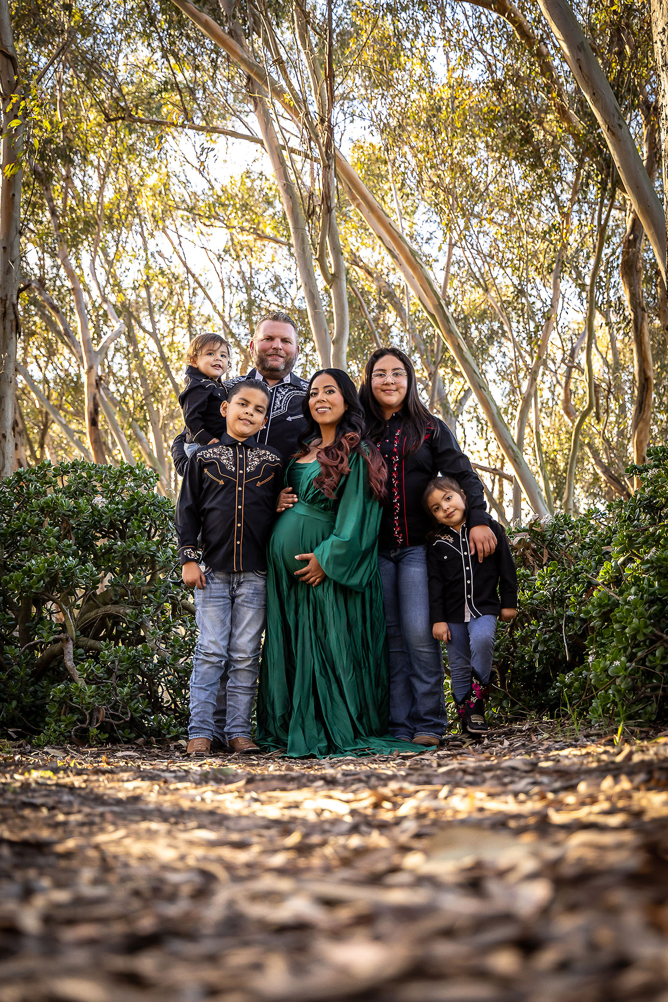family in a forrest looking happy