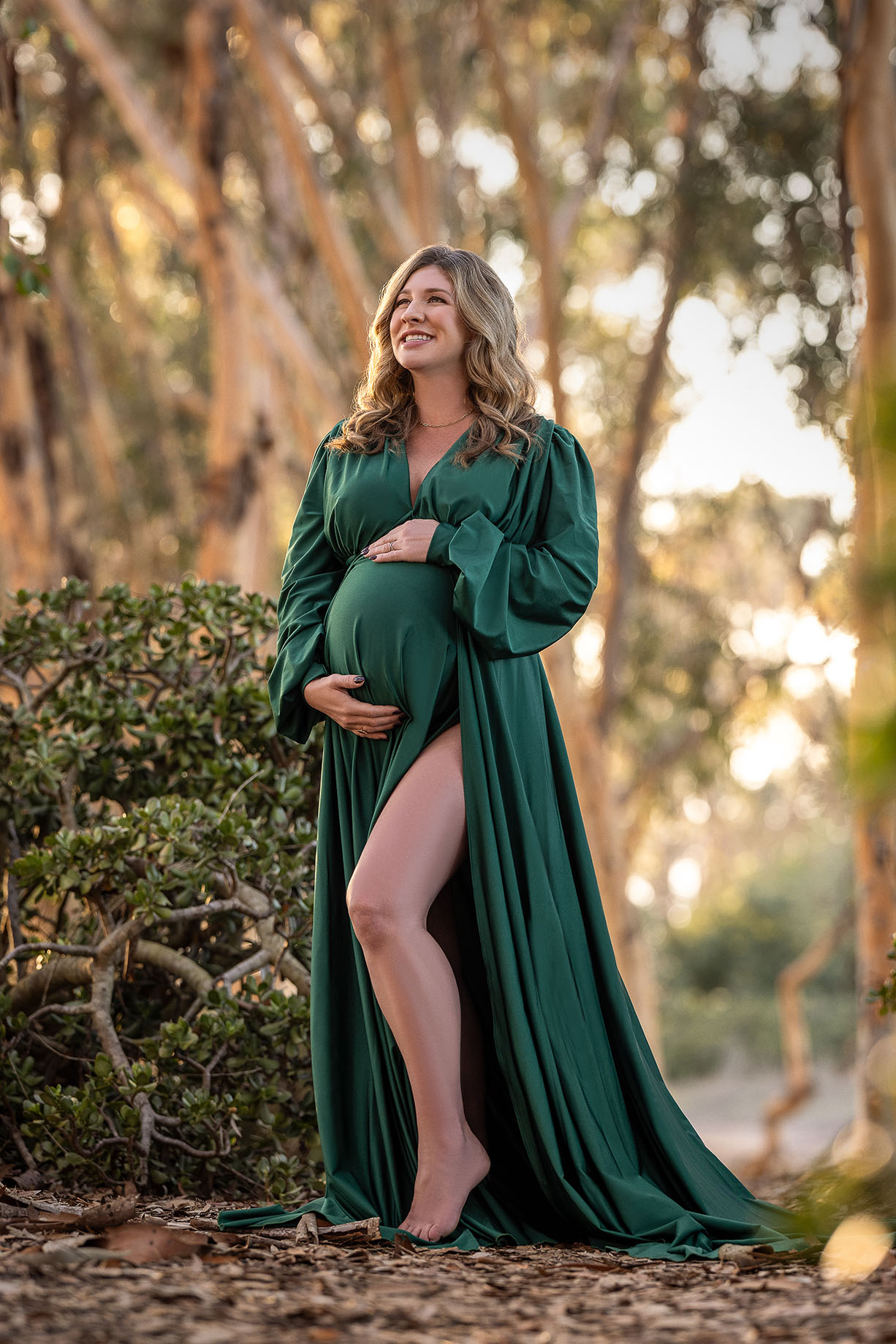 pregnant mom in forrest with custom green dress